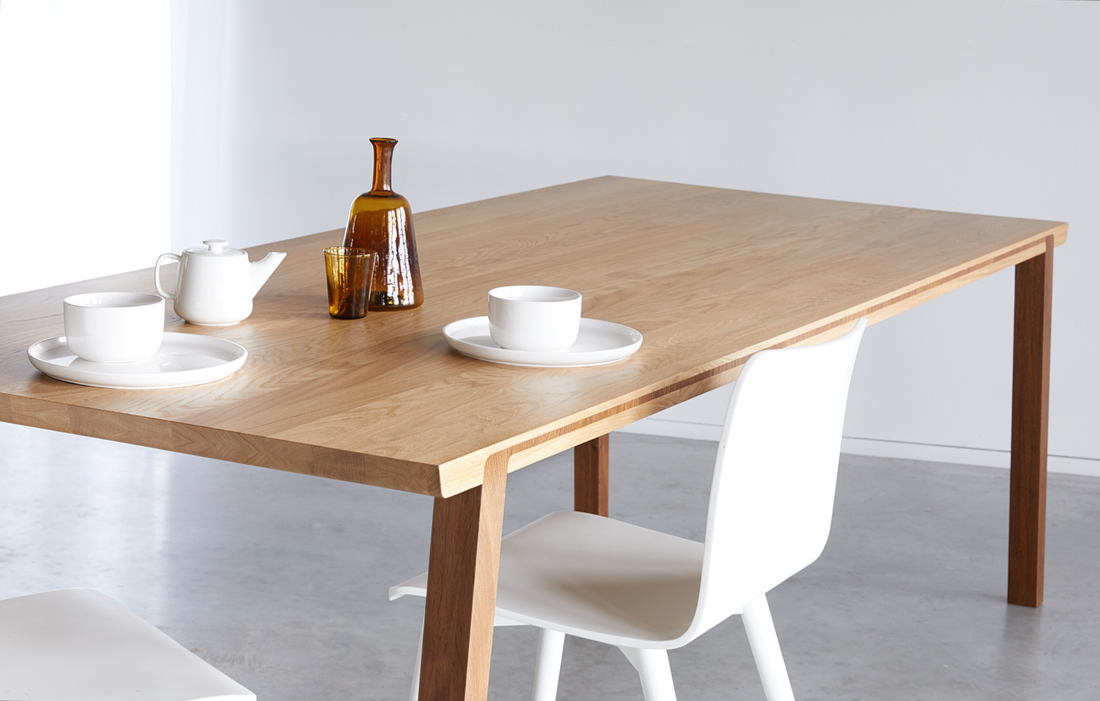 Massief houten tafel waarbij de poten doorlopen in het blad.